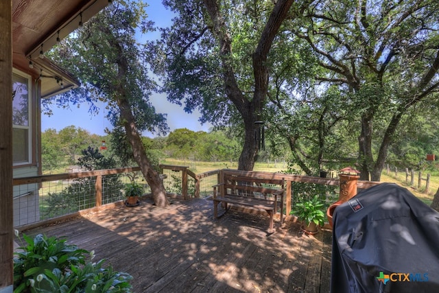 wooden terrace with a grill