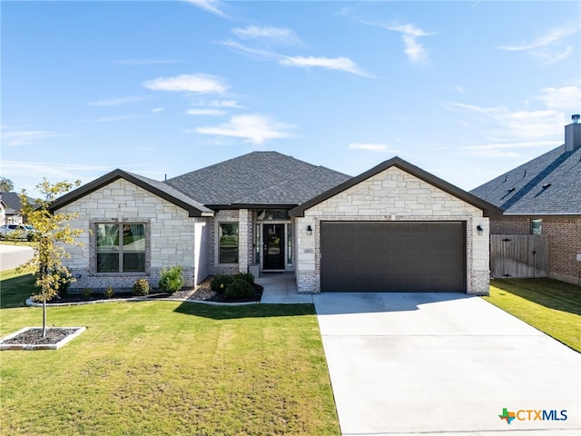 view of front of property with a front yard and a garage