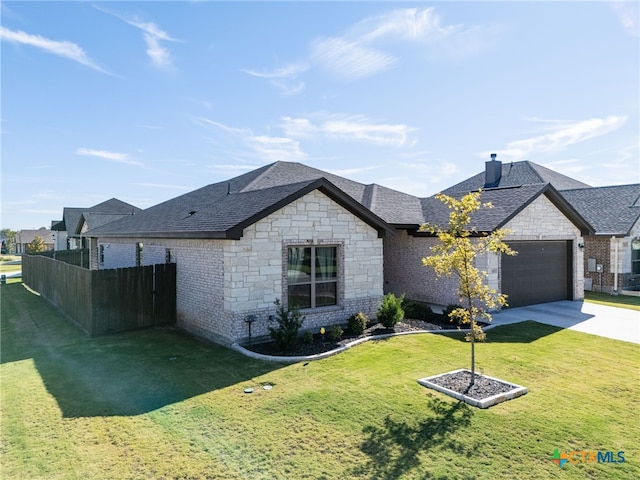 view of front of home with a front yard and a garage