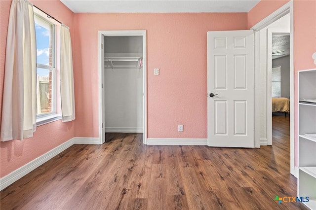 3801 Joshua Taylor Dr, Killeen, TX 76549 - unfurnished bedroom with baseboards, wood finished floors, a closet, and a textured wall