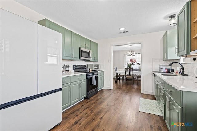 3801 Joshua Taylor Dr, Killeen, TX 76549 - kitchen featuring green cabinetry, stainless steel microwave, black / electric stove, freestanding refrigerator, and light countertops