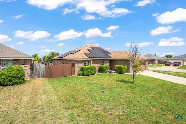 3801 Joshua Taylor Dr, Killeen, TX 76549 - ranch-style house with solar panels, driveway, a gate, a garage, and brick siding