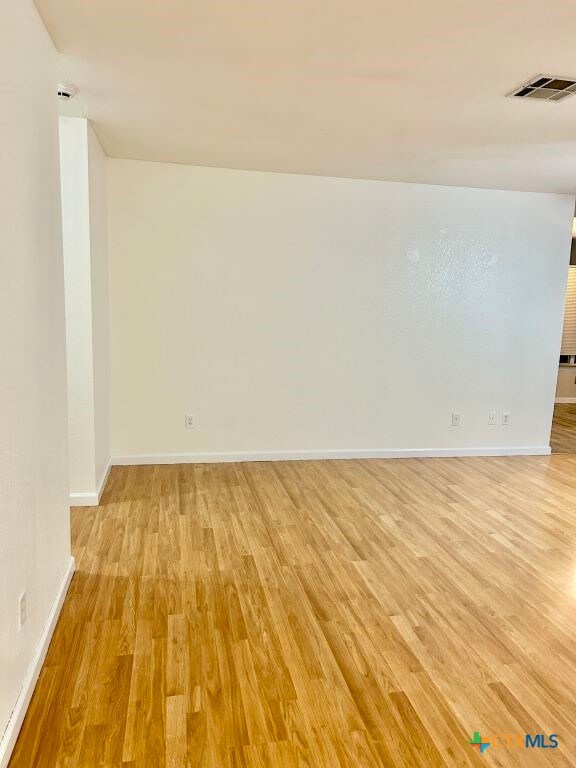 spare room featuring light wood-type flooring