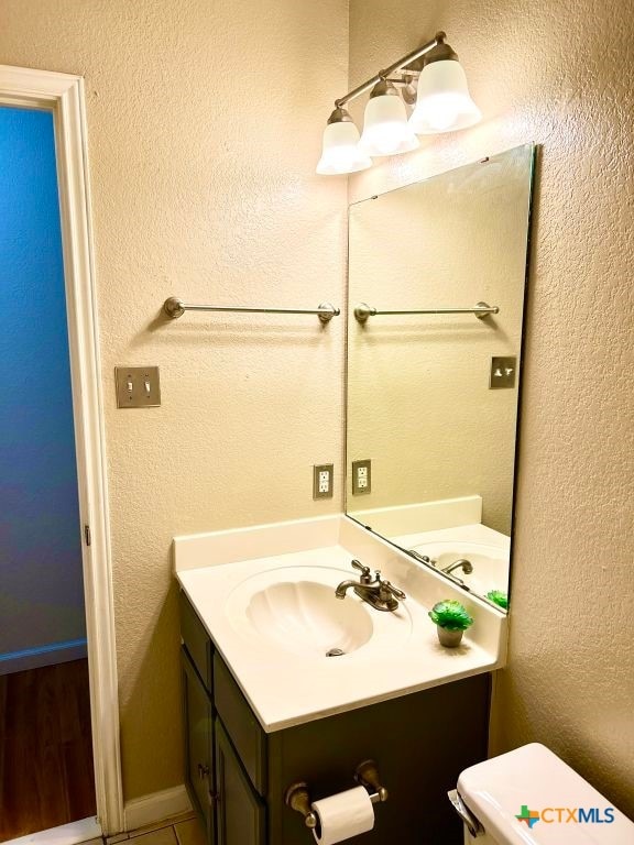 bathroom featuring toilet and vanity