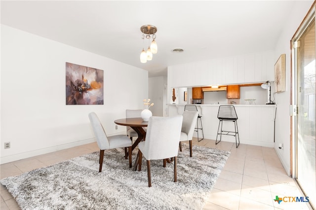 dining space featuring light tile patterned floors