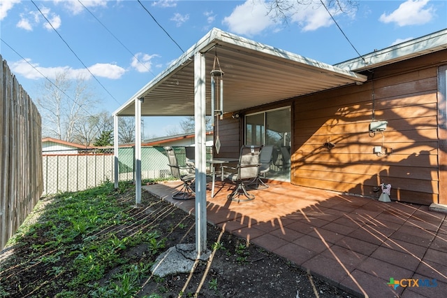 view of side of property with a patio area