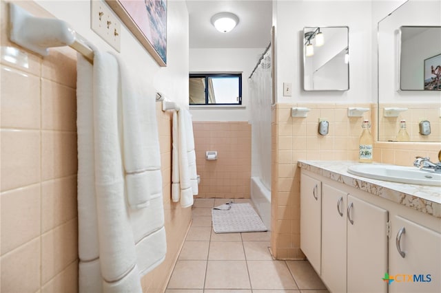 bathroom featuring tile walls, tile patterned flooring, vanity, and shower / bath combo with shower curtain