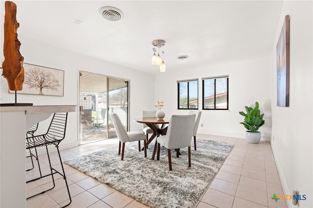 dining area featuring light tile patterned floors