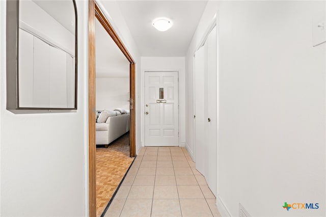 corridor featuring light tile patterned flooring