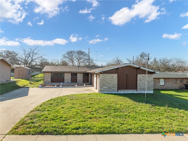 single story home featuring a front yard and a storage shed