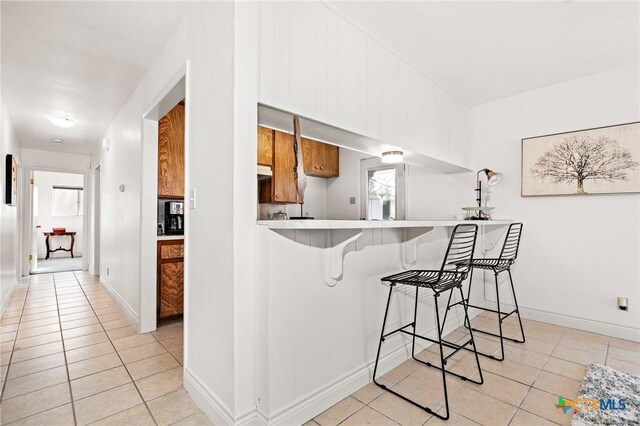 kitchen featuring appliances with stainless steel finishes, sink, and light tile patterned floors