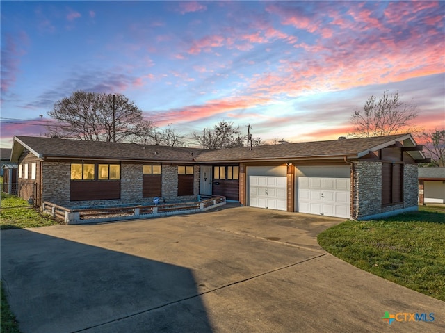 view of front of house featuring a garage and a yard