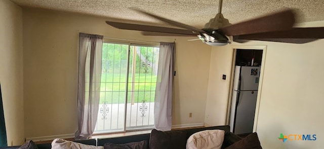 interior space featuring ceiling fan and a textured ceiling