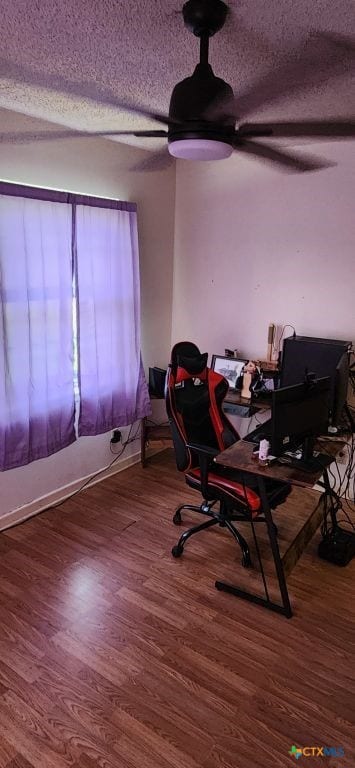 office area featuring hardwood / wood-style floors, a textured ceiling, and ceiling fan