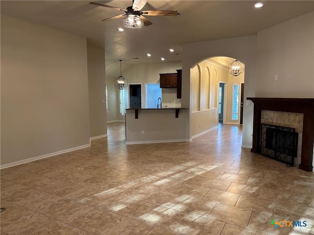 unfurnished living room with ceiling fan and sink