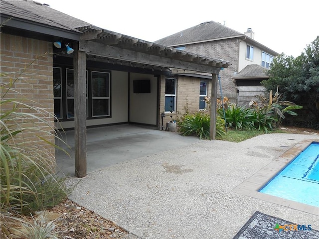 back of house with a pergola and a patio