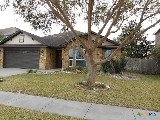 ranch-style house with a front yard and a garage