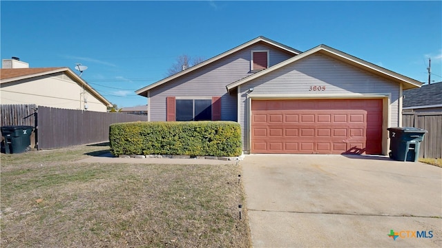 view of front facade featuring driveway, an attached garage, fence, and a front yard