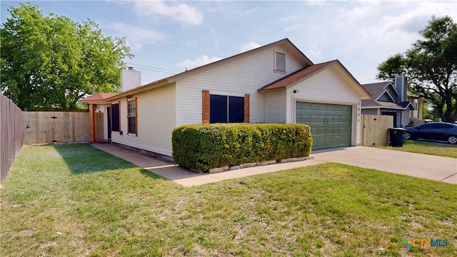 ranch-style home with concrete driveway, a chimney, an attached garage, fence, and a front yard