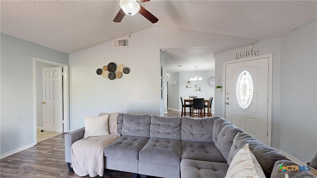 living area with baseboards, visible vents, wood finished floors, vaulted ceiling, and a textured ceiling