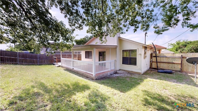back of property featuring a fenced backyard and a lawn