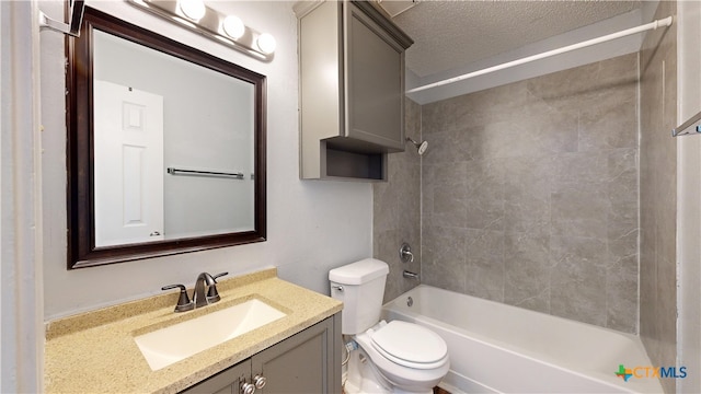 bathroom with a textured ceiling, toilet, vanity, and bathing tub / shower combination
