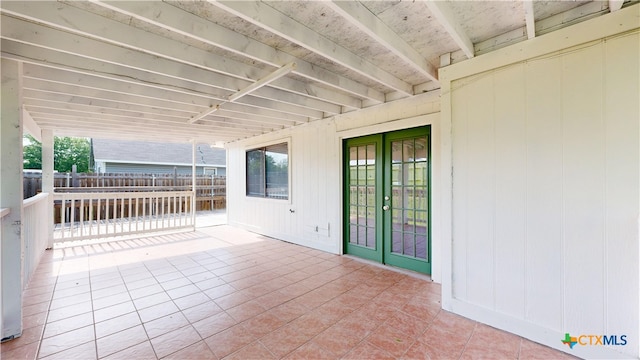 view of patio featuring french doors and fence