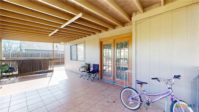 view of patio featuring french doors and fence