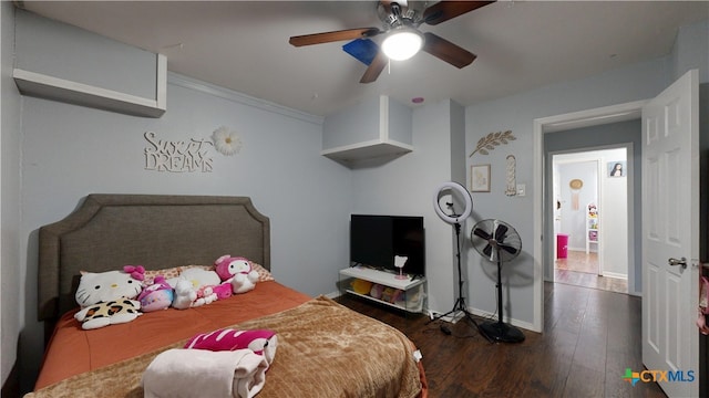 bedroom featuring dark wood-style floors, a ceiling fan, and baseboards