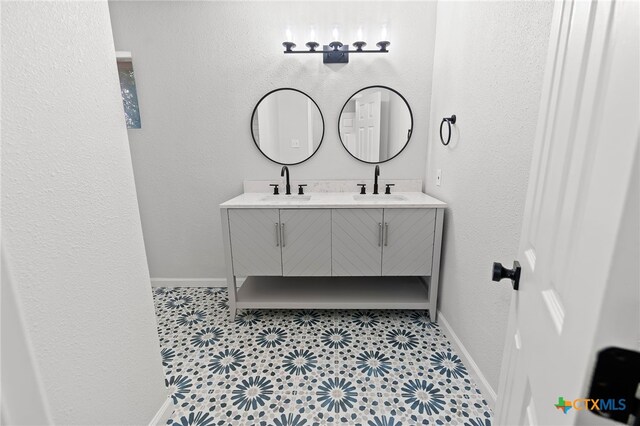 bathroom featuring tile patterned flooring and vanity