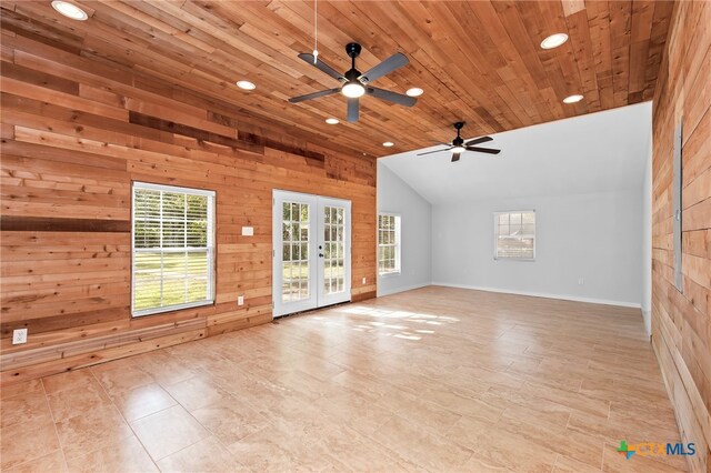 spare room with wood walls, ceiling fan, high vaulted ceiling, wood ceiling, and french doors