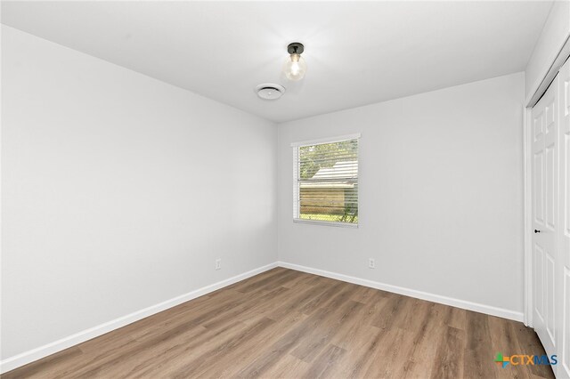 interior space featuring hardwood / wood-style flooring and a closet