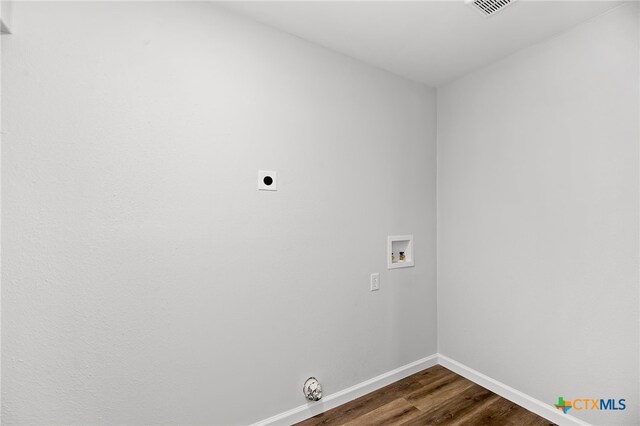 clothes washing area with dark wood-type flooring, hookup for a washing machine, and electric dryer hookup