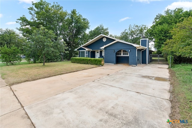 ranch-style home featuring a carport and a front yard