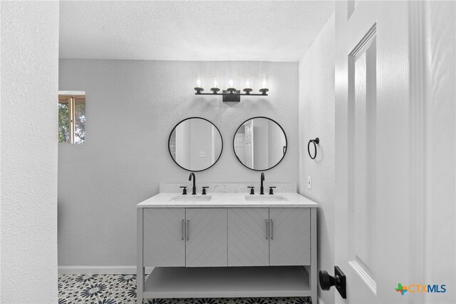 bathroom with vanity and a textured ceiling