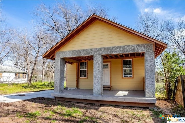 rear view of house with a porch