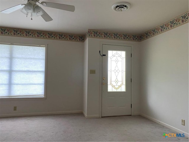 589 Bluebonnet Ln, Yoakum, TX 77995 - foyer with baseboards, ceiling fan, light carpet, and a wealth of natural light