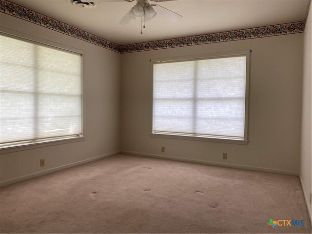 589 Bluebonnet Ln, Yoakum, TX 77995 - unfurnished room featuring light colored carpet, baseboards, and ceiling fan