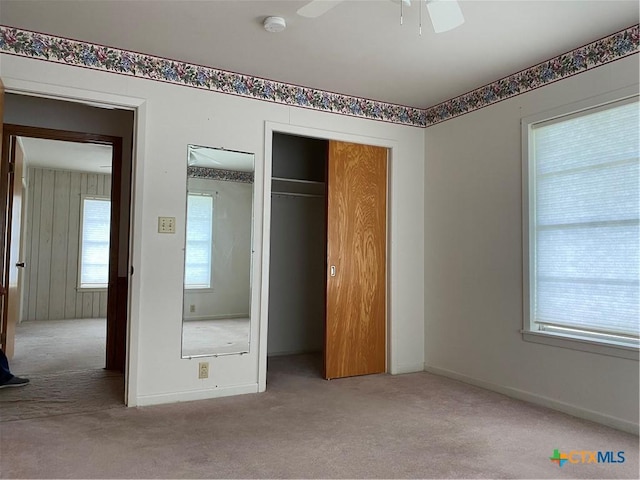589 Bluebonnet Ln, Yoakum, TX 77995 - unfurnished bedroom with a closet, carpet, ceiling fan, and baseboards
