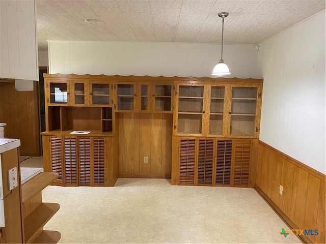 589 Bluebonnet Ln, Yoakum, TX 77995 - interior space featuring crown molding, tile patterned floors, wood walls, and wainscoting