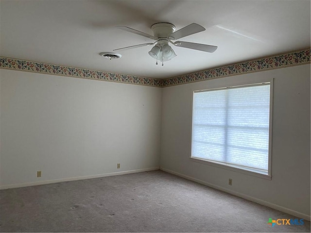 589 Bluebonnet Ln, Yoakum, TX 77995 - spare room with baseboards, light carpet, a ceiling fan, and visible vents