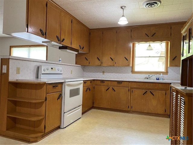 589 Bluebonnet Ln, Yoakum, TX 77995 - kitchen with light countertops, light floors, white electric range, and brown cabinets