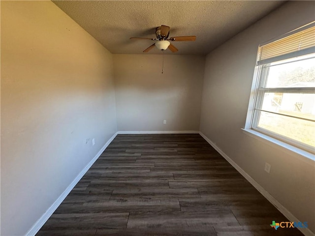 spare room with ceiling fan, a textured ceiling, and dark hardwood / wood-style floors