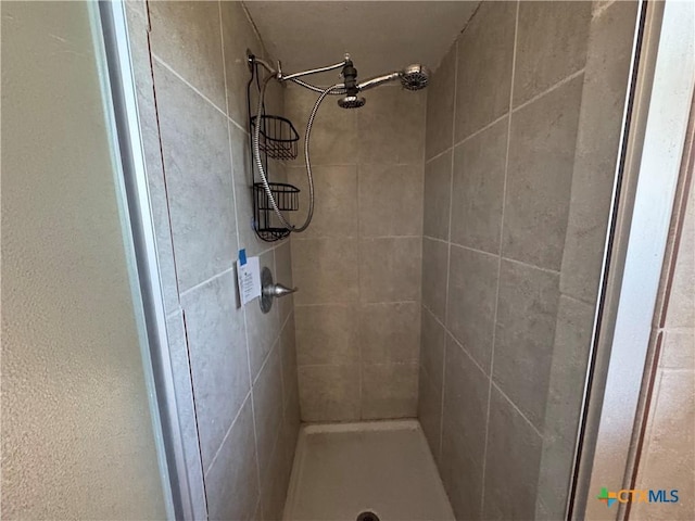 bathroom with a tile shower