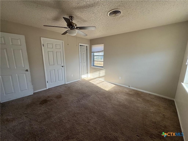 unfurnished bedroom with a textured ceiling, carpet flooring, and ceiling fan