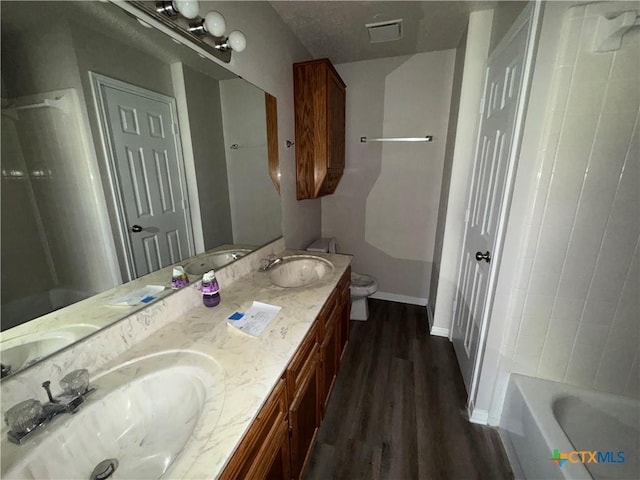 bathroom with vanity, toilet, and hardwood / wood-style floors