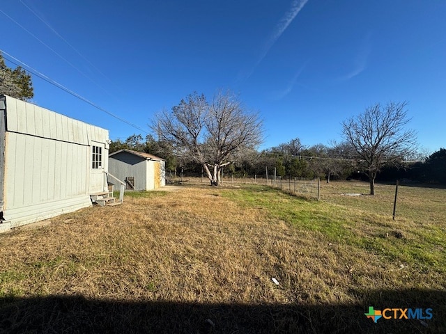 view of yard with a rural view