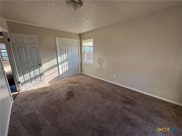 spare room featuring carpet and a textured ceiling