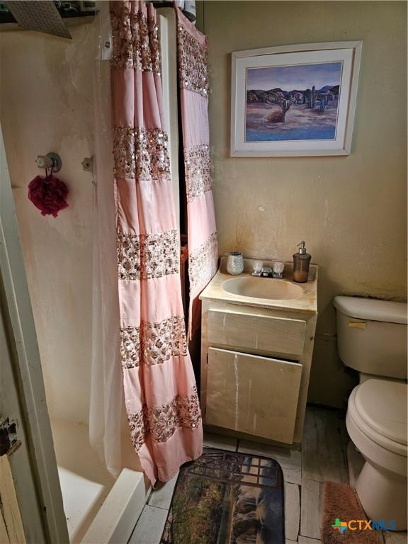 7318 Cryer Ln, Temple, TX 76502 - bathroom with toilet, a shower stall, vanity, and tile patterned floors