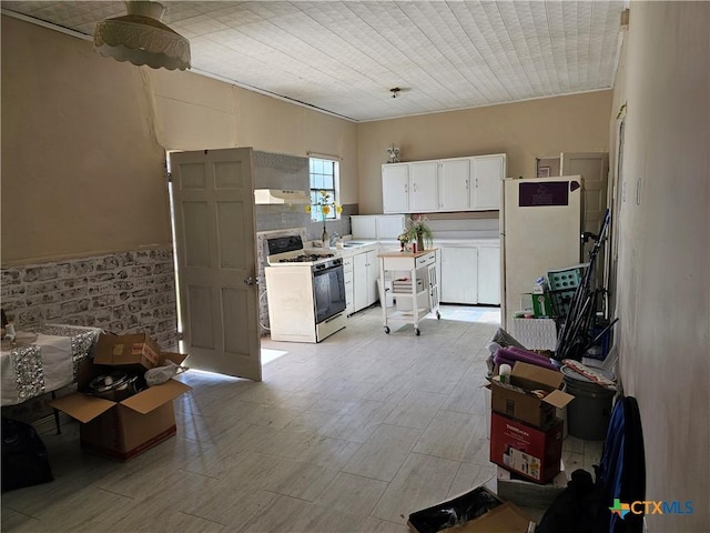 7318 Cryer Ln, Temple, TX 76502 - kitchen featuring white appliances, light wood-type flooring, white cabinetry, light countertops, and under cabinet range hood